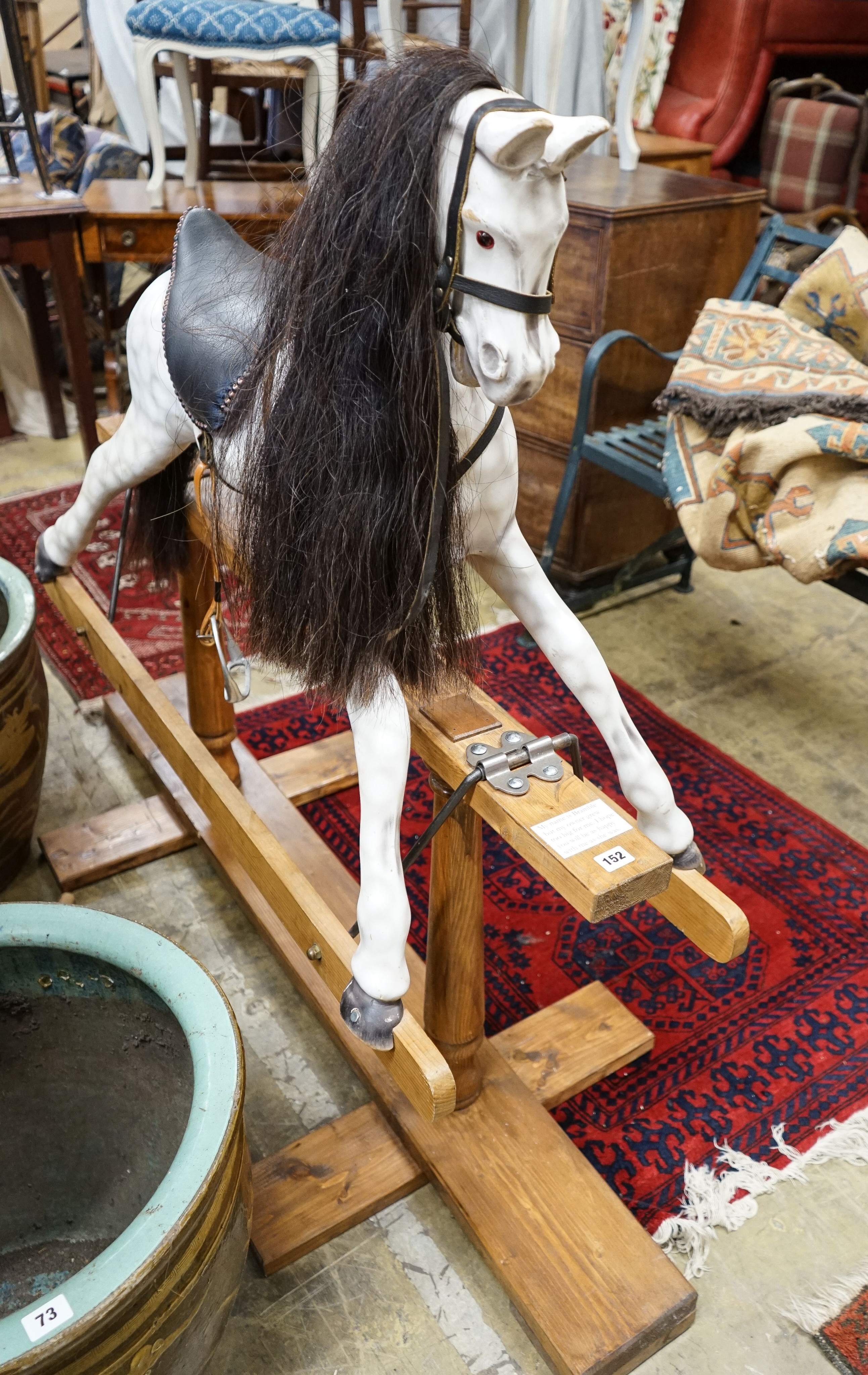 A Victorian style dapple grey rocking horse on pine stand, length 152cm, height 126cm